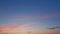 Peaceful sky over horizon. Nature sunset time. Purple fluffy clouds and blue sky. Timelapse.