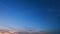 Peaceful sky over horizon. Nature sunset time. Purple fluffy clouds and blue sky. Timelapse.