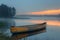 The peaceful solitude of a canoe on a misty lake at dawn