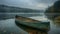 The peaceful solitude of a canoe on a misty lake at dawn