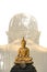 A peaceful superimposed and double exposure images of Golden Buddha statue with forest atmosphere on a clean and white background.