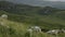 A peaceful tableau of a flock of sheep grazing amidst the grandeur of towering mountains. pano