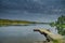 Peaceful tranquill view of dusky evening nature from a lake side with wooden floating bridge in the water during the summer in