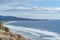 Peaceful view of calm beach in San Diego California bordered by steep mountain