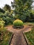 Peaceful view of lake and flowers in bloom at Biddulph Grange, Stoke-on-Trent, England