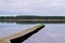 Peaceful view of sanguinet lake with ducks bird resting on wooden pier dock in landes france