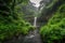 peaceful waterfall, surrounded by lush greenery and misty clouds