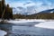 Peaceful winter scene along the Kootenay River in Kootenay National Park British Columbia. Pillows of snow along the riverbaks