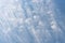 Peaceful wispy white clouds against a clean blue sky as a nature background