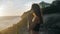 Peacefull girl praying looking up at orange sky with hope, close-up. Silhouette of young woman dreaming looking upwards