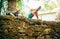 Peacefully Sleeping young female backpacker liying on the old stone castle fance and enjoying a rest time on the Way of Camino de