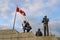 The Peacekeeping Monument, flag of Canada and cloudy sky.