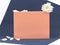 Peach color cardboard gift box mock up decorated with white flower and petals on dark blue background. Copy space