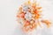 peach color dried flower bouquet from cereal ears cotton and craspedia on snow. reasonable consumption of natural materials