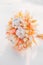 peach color dried flower bouquet from cereal ears cotton and craspedia on snow. reasonable consumption of natural materials