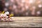 Peach flowers on branches against a wooden backdrop with text space