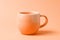 A peach fuzz color mug on minimal background