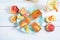 Peach ice cream on a stick in a blue plate and ice cubes, peach refreshing juice in a glass with ice and pieces of fruit and mint