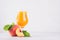 Peach juice in elegance glass with juicy piece peaches on light white wood table, copy space.