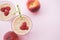 Peach smoothies with milk yogurt, raspberries and striped stra
