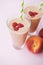 Peach smoothies with milk yogurt, raspberries and striped stra