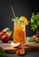 Peach tea with ice and mint on tall glass. Vegan homemade cold summer drink on a wooden board on a dark background with fresh