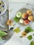 Peaches, apples, plums, leaves on plates on a light background