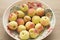 Peaches and colorful bowl. Fruits on wooden table.