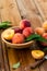 Peaches with leaves in a wooden bowl with peach in halves on top. Flat lay composition with ripe juicy peaches. Harvest of peaches