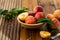 Peaches with leaves in a wooden bowl with peach in halves on top. Flat lay composition with ripe juicy peaches. Harvest of peaches