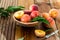 Peaches with leaves in a wooden bowl with peach in halves on top. Flat lay composition with ripe juicy peaches. Harvest of peaches