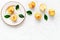 Peaches pattern with plate and leaves on white table top-down copy space