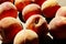 Peaches scattered on a wooden table, top view, horizontal image.