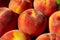 Peaches scattered on a wooden table, top view, horizontal image.