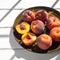 Peachs on plate with light and shadows, rustic style