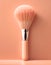 Peachy hue 2024 year trend. Makeup brush enhances facial features against a peach color backdrop