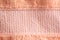 Peachy soft warm fabric. Peach velvet background material, macro