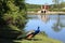 Peacock, garden and lake at Egeskov castle