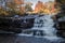 Peak fall foliage surrounds beautiful cascading lower Shohola Falls