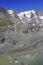 The peak of Grossglockner mountain is reflected in the water collected from the melting Pasterze glacier.