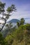 The peak of Mount Merbabu as seen from Mount Telomoyo with vegetation and trees as the foreground