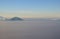 Peak of mountain visible above the clouds during sunset