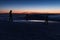 The peak of the Snezka Mountain in winter in the Krkonose Mountains. Group of tourists with lights on the summit of Snezka.