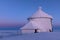 The peak of the Snezka Mountain in winter in the Krkonose Mountains. Snezka after a sunset tinged in beautiful pastel colors. Buil