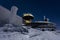 Peak of Sniezka mountain at night with stars sky in Giant mountains during winter