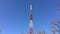 Peak of a telecommunications tower against the blue sky