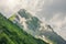 Peak of the top of the mountain with rising steam of clouds along the slopes