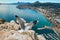 On the peak top of Penon de Ifach cliff flying seagull. Picturesque view from top to the Calpe cityscape, Mediterranean Sea and