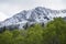 Peak with Utah Snow capped mountains with rolling green hills