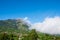 The peak of Volcano In Indonesia, showing ash and burnt landscape of recent eruption and the lush surrounding landscape